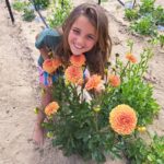 Girl Showing off Dahlia plants
